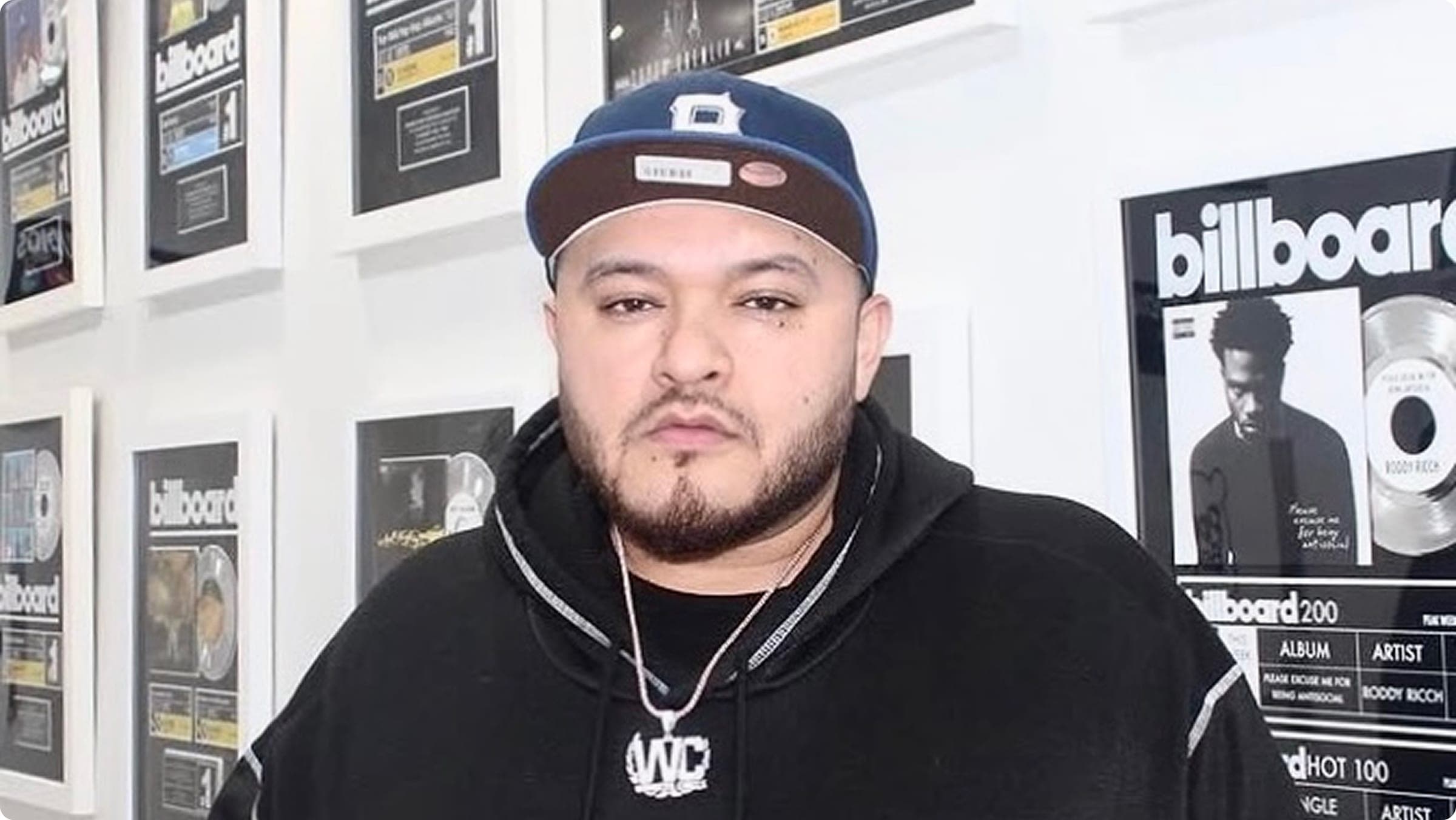 Yak Beats in the studio, surrounded by equipment and working on music production.